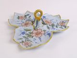 a blue and pink flowered plate with a gold ring on it