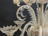 a glass chandelier that is hanging from the ceiling