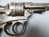 an old gun is sitting on a table with a white background