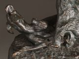 a bronze statue of a man and a dog on a rock