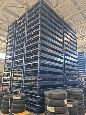 a large stack of tires sitting on top of a pallet in a warehouse