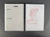an open notebook with a drawing of a woman sitting on a chair