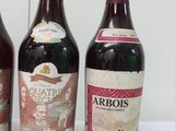 three bottles of wine are lined up on a table