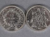 two silver coins, one of which is a woman and one of which is a man