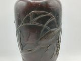 a brown vase that is sitting on a table