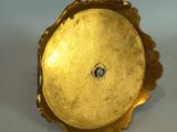 a gold plate with a diamond in it on a table