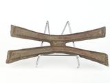 a wooden object that is sitting on a metal stand