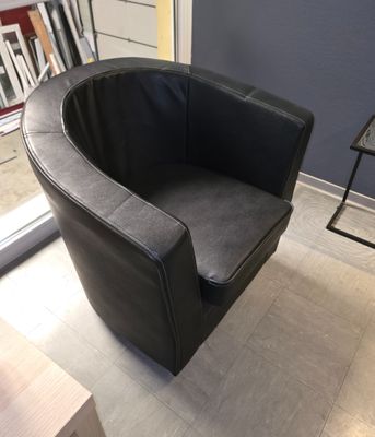 une chaise noire qui se trouve dans une pièce