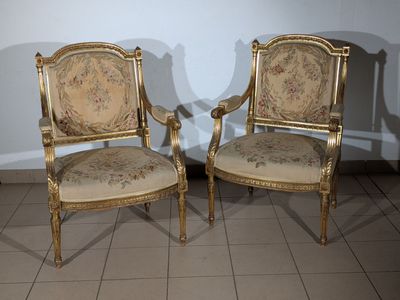 two chairs sitting next to each other on a tiled floor