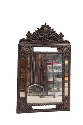 a mirror that is sitting on the floor in front of a chair