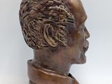 bronze bust of a man wearing a collared shirt and tie