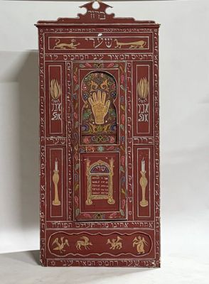 an image of a red cabinet with gold decorations on it