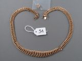 a close up of a gold chain with a tag on it