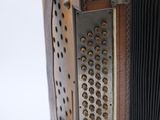 a close up of an old accordion with buttons on it