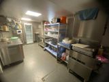 a view of a commercial kitchen with a lot of counter space
