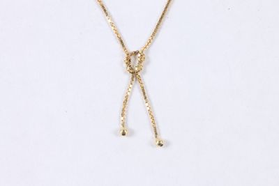 a close up of a necklace on a white surface