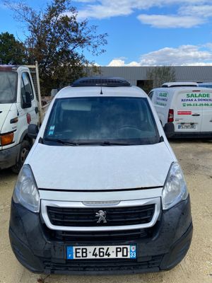 a white van parked in a parking lot next to other vans