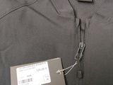 the back of a black jacket with a tag on it