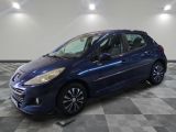 a blue car is parked on a checkered floor in a garage