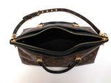 the inside of a brown louis vuitton bag on a white surface