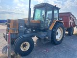 a tractor that is parked on the side of the road