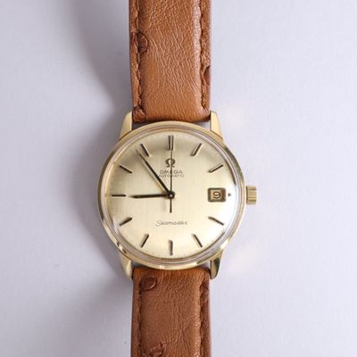 a watch that is sitting on a white surface