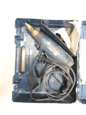 a tool in a box with a cord and a drill