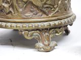 a bronze vase with a bird on it on a stand
