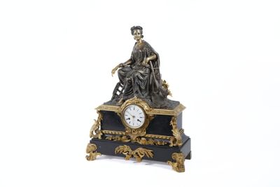 a statue of a man sitting on top of a clock