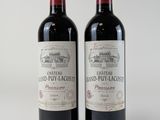 deux bouteilles de vin rouge posées l'une à côté de l'autre sur une surface blanche