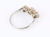 a close up of a ring with three stones on top of it