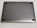 the back of a silver laptop computer sitting on top of a white table
