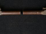 an old gun with a wooden handle on a black background