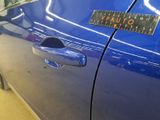 a blue car with a sticker on the side of it