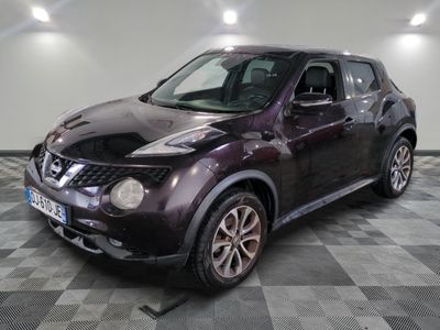 the nissan juke is parked in the garage on a checkered floor