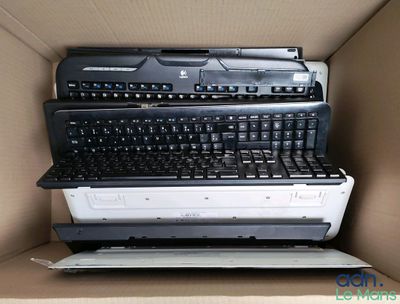 a cardboard box with a bunch of computer keyboards in it