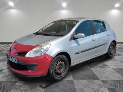 the small silver and red car is parked on a checkered floor