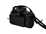 a camera with a strap attached to it on a white background