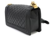 a black quilted purse with gold hardware on the handle