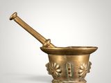 a brass mortar and pestula with a wooden handle on a white background