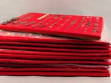 a stack of red books sitting on top of each other