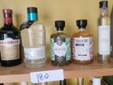 many bottles of alcohol sitting on a shelf in a room
