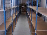 a long row of shelves in the middle of a room