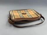 a brown and tan purse sitting on top of a table