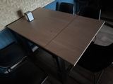 a table with a cell phone on it next to a chair
