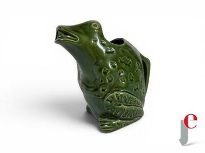 a green frog shaped vase on a white surface