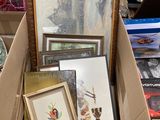 a box full of assorted framed and framed art