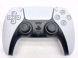 a close up of a video game controller on a white surface