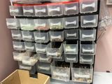 many bins of food on a shelf in a room