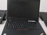three laptops sitting on a white table next to each other